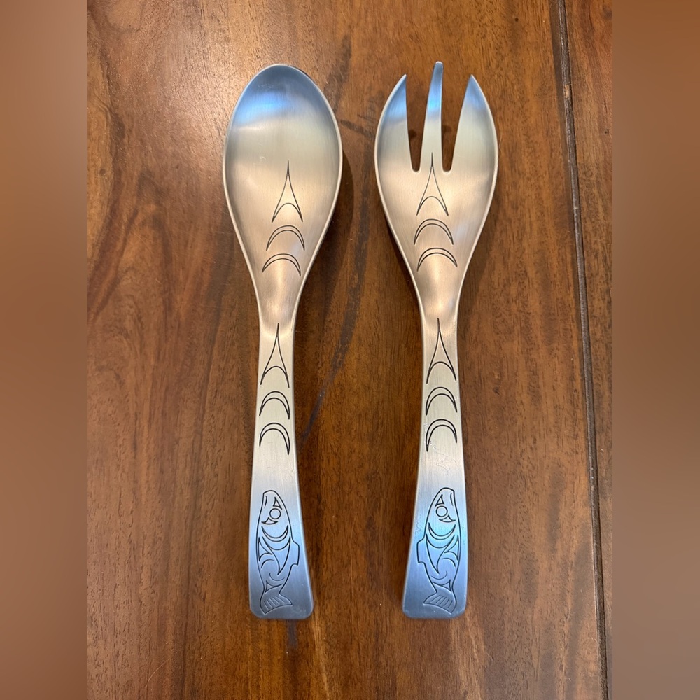 A set of Native Essence pewter salad servers featuring a Salmon Spirit design.